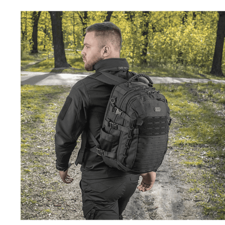 Man wearing M-Tac Mission Pack Elite backpack in forest setting, made of durable Cordura 1000D with MOLLE LASER CUT system.