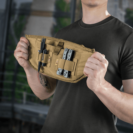 Man holding M‑Tac Belt Bag Elite Hex with tools in the pockets, demonstrating capacity and functional design for everyday use.