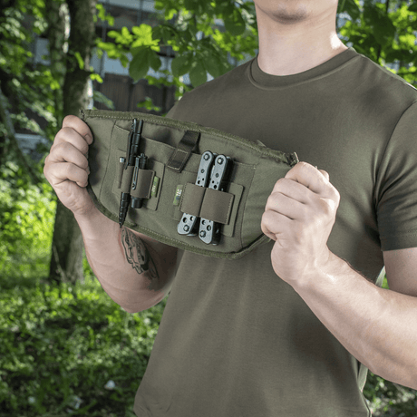 Man shows M‑Tac Belt Bag Elite Hex with tools, ideal for tactical and everyday use, made of Cordura, with modular pockets.