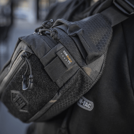 M‑Tac Elite Hex belt bag shown worn by a person, made in Cordura with YKK zippers, ideal for daily or tactical use.