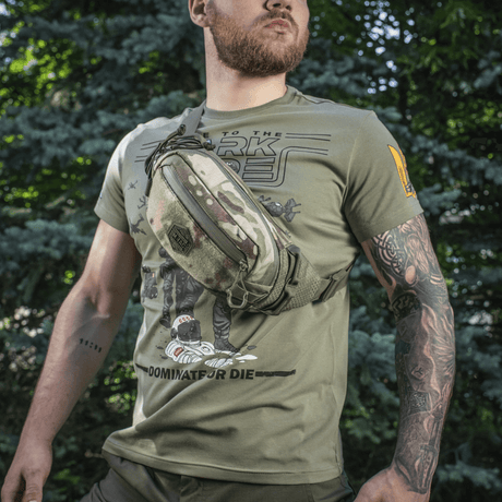 M‑Tac Elite Hex belt bag on a man in the forest, stylish and functional thanks to Cordura material and tactical pockets.