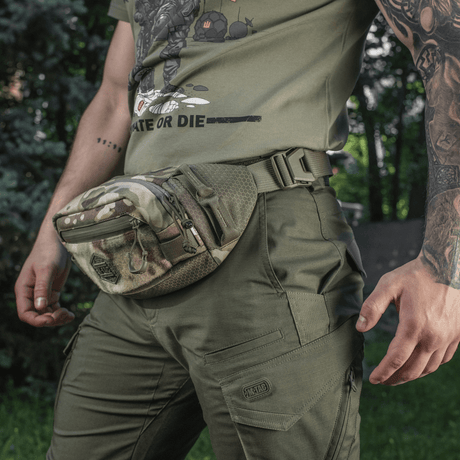 M-Tac Elite Hex belt bag in camouflage, durable Cordura material, on a person wearing green outdoor clothing.