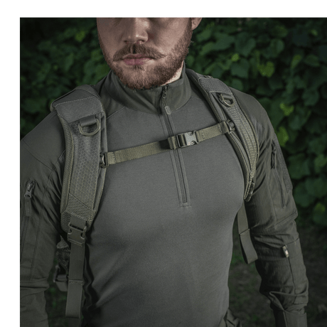 Man wearing M-Tac Mission Backpack Elite Hex made from Cordura 1000D with ergonomic design and MOLLE LASER CUT system in a forest environment.