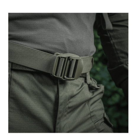 Man wearing M-Tac Mission Backpack Elite Hex with Cordura material and MOLLE LASER CUT system, close-up on the belt.