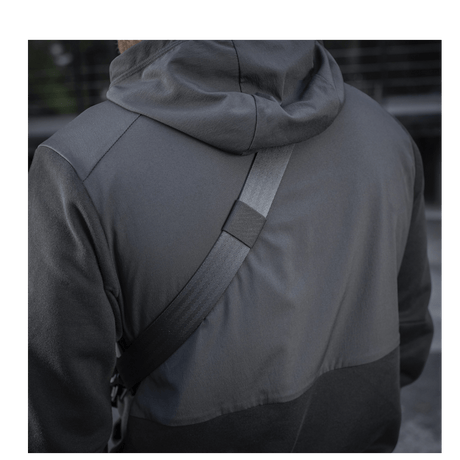 Person with M-Tac Cross Bag Slim Elite Hex wearing a black jacket.