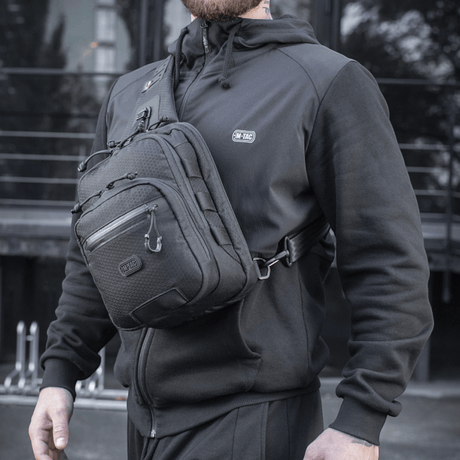 M-Tac Cross Bag Slim Elite Hex worn by a person in black clothing, outdoor setting.