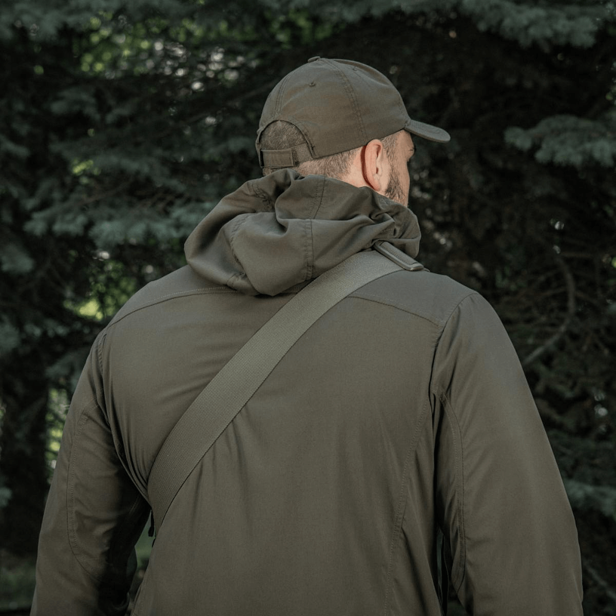 Person wearing M-Tac Tablet Bag Laser Cut Hex over shoulder, outdoors