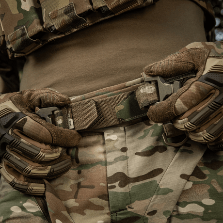 M-Tac Cobra Buckle Tactical Belt Laser Cut in use, worn by a person in camouflage clothing and gloves.