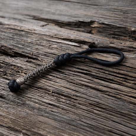 M-Tac Knife Lanyard Scandinavian braided paracord, a stylish and practical accessory for pocket knives on a wood background.