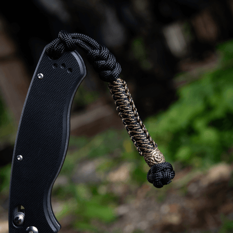M-Tac Knife Lanyard Scandinavian - braided paracord lanyard on a pocket knife for stylish and practical use.