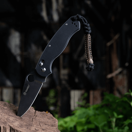 M-Tac Knife Lanyard Scandinavian paracord accessory on a pocket knife in natural surroundings for style and function.