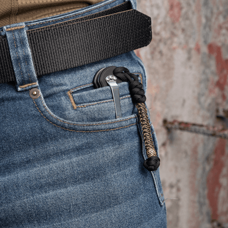 M-Tac Knife Lanyard Scandinavian braided paracord on a pocket knife in a trouser pocket, a stylish and practical accessory.