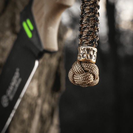 M-Tac Knife Lanyard Scandinavian Granule in braided paracord with decorative knot attached to a knife, practical and stylish accessory.