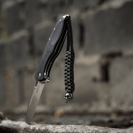 Black M-Tac Knife Lanyard Cuboid Skull paracord with decorative Cuboid Skull bead, braided for knives, unique look and practical use.
