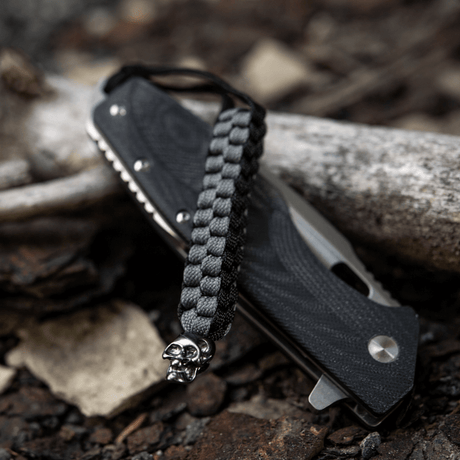 M-Tac Knife Lanyard Cuboid Skull with raw paracord design and decorative skull bead, practical as a handle extension for knives.