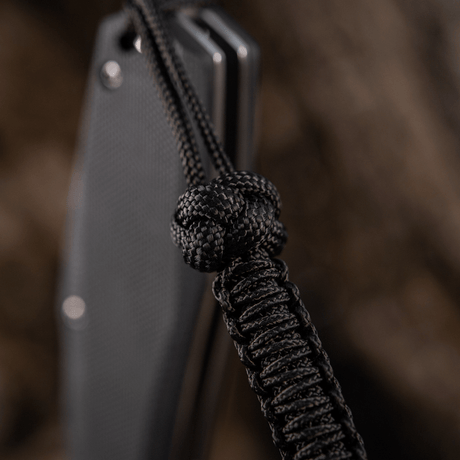 M-Tac Knife Lanyard Celtic, a braided black paracord lanyard that highlights a knife's design and practical functionality.