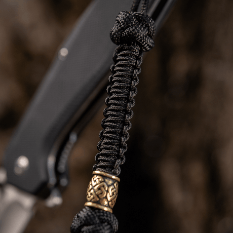M-Tac Knife Lanyard Celtic in black braided paracord with decorative detail, adds style to a knife and makes it easier to find.
