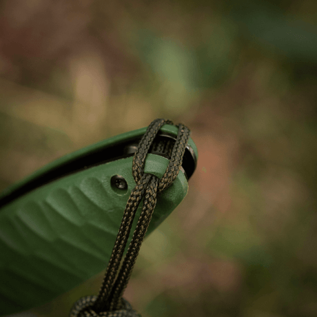 M-Tac Knife Lanyard Celtic on a gray outdoor knife, highlights a stylish braided design made of durable paracord.