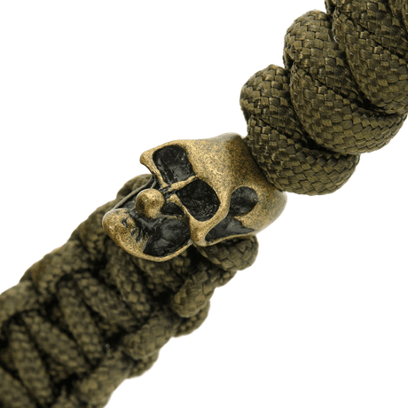 Detail of olive green M-Tac Loopy Snake Skull Lanyard, shown with braided paracord and decorative metal skull, for knife and gear.