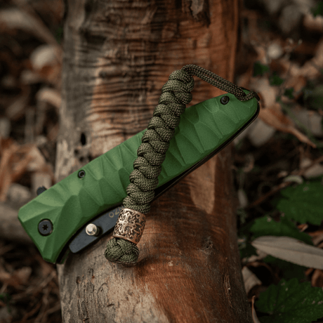 M-Tac Viper Lanyard Scandinavian paracord with Viper bead in a natural setting, ideal for knives and pocket accessories, wear-resistant and stylish.