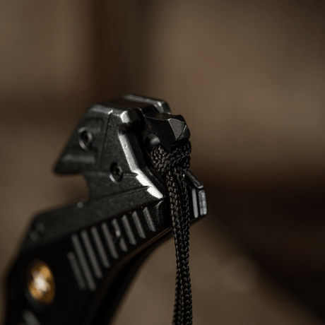 Detail image of M-Tac Zeus Lanyard, braided with paracord for quick access and stylish design, tied to knife handle.