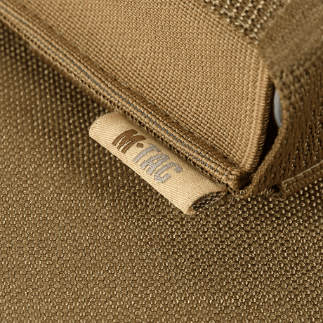 Detail of M-Tac Gasdåseholder Vertikal with MIL-SPEC strap in brown fabric material and branded logo.
