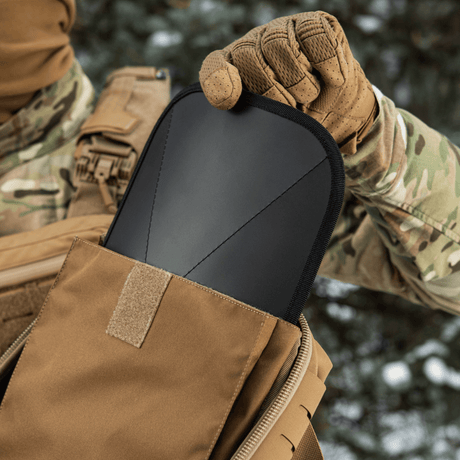 Soldier with M-Tac Sturm Elite Gen.II showing the backpack's internal compartment designed for self-sufficient field trips.