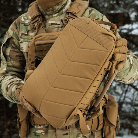 M-Tac Sturm Elite Gen.II backpack held by person in camouflage gear.