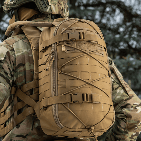M-Tac Sturm Elite Gen.II backpack with MOLLE system and elastic bungee, designed for the field, seen on a soldier in camouflage.
