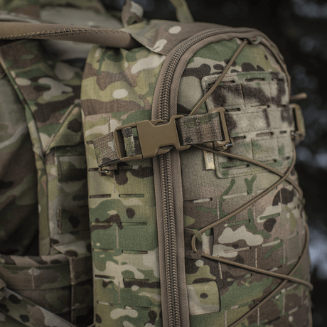 Close-up of M-Tac Sturm Elite Gen.II backpack with MOLLE Laser Cut system and bungee cord for jacket or camouflage net.