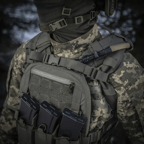 M-Tac Sturm Elite Gen.II worn by a soldier in camouflage with tactical gear and MOLLE system visible at front.