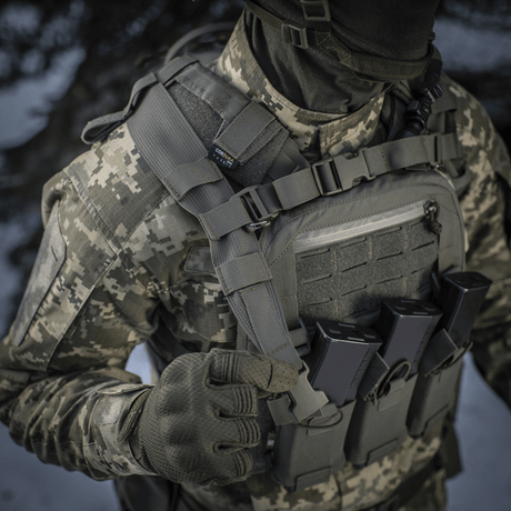 Military gear with MOLLE Laser Cut system and camouflage uniform.