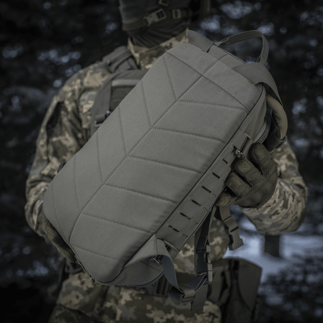 Tactical M-Tac Sturm Elite Gen.II held by a person in camouflage gear.