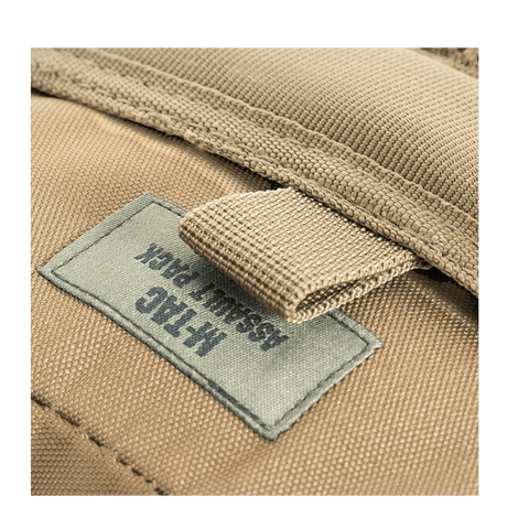 M-Tac Assault Pack with MOLLE system and padded shoulder straps, close-up of label on the beige backpack