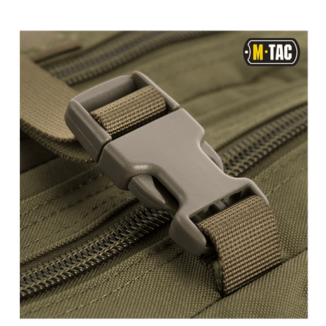 Close-up of the buckle system on M-Tac Assault Pack, showing construction and MOLLE compatibility