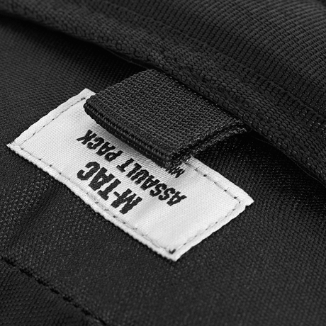 M-Tac Assault Pack Laser Cut label on a black backpack with MOLLE system, perfect for city use and short hikes.