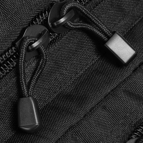 Close-up of zipper on M-Tac Assault Pack Laser Cut, robust polyester design with zipper pulls for durability.