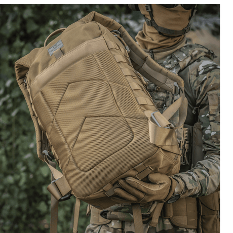 Soldier with M-Tac Large Assault Pack Backpack in urban camouflage pattern, showing MOLLE attachment system and comfortable shoulder straps