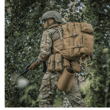 M-Tac Large Assault Pack Backpack in use by a person in camouflage clothing in a forest environment, with MOLLE system and adjustable shoulder straps