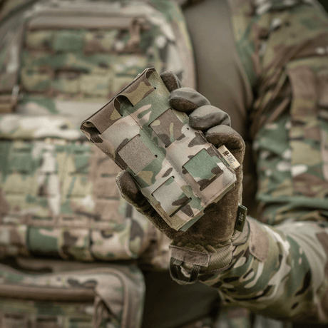 M-Tac Double Magazine Pouch APS Laser Cut in use, held by a person in military camouflage clothing. Lightweight, compact design for APS magazines.