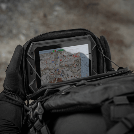 M-Tac Admin Pouch Large Elite in use under field conditions for storing tactical gadgets like a tablet and maps.