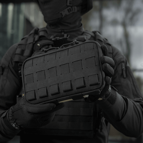 Person holding M-Tac Admin Pouch Large Elite in black, functional pouch for tactical gear made from Cordura 500D with velcro and laser-cut details.