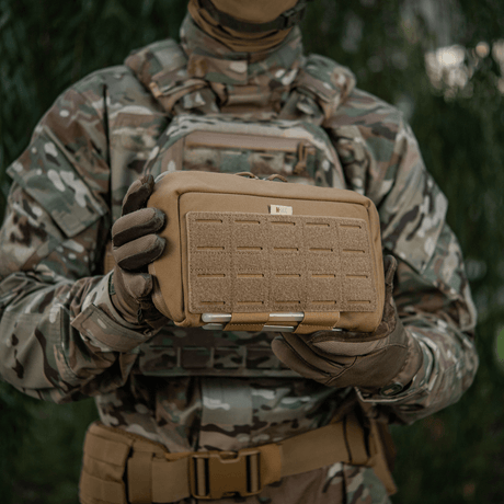 M-Tac Admin Pouch Large Elite, tactical pouch in camouflage, held by a soldier in field gear.