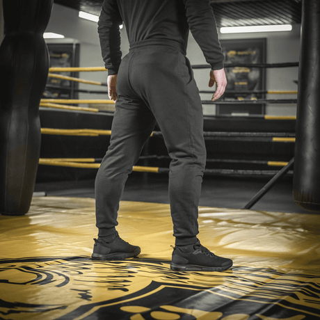 Person wearing M-Tac Cotton Classic pants in a boxing ring, ideal for sport and everyday use, made of comfortable 100% cotton.