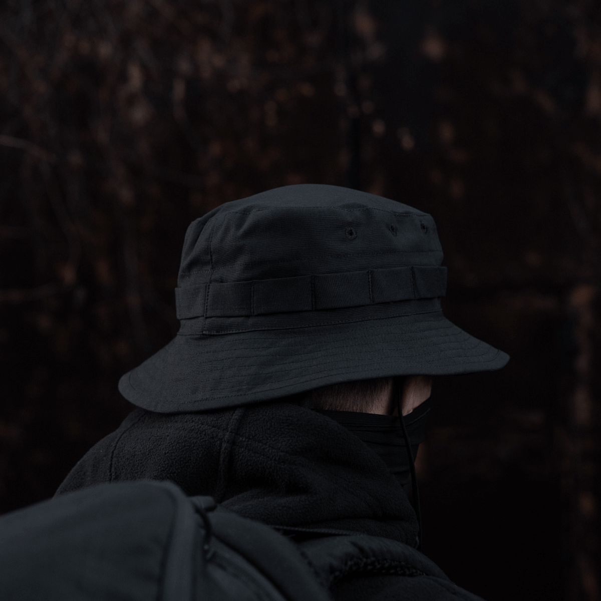 M-Tac Panama Rip-Stop hat with semi-stiff brim, camouflage band, and ventilation holes, worn outdoors in dark setting.