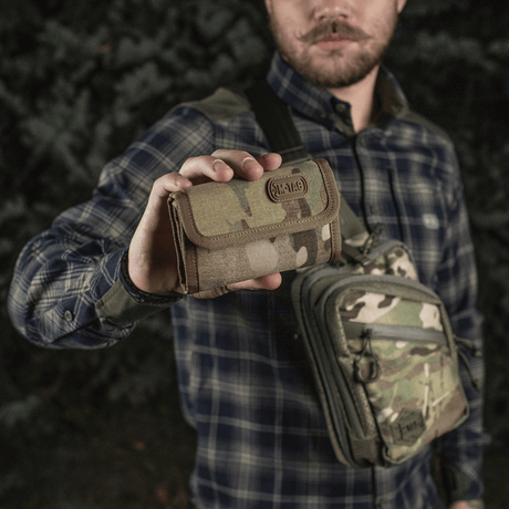 Man holding M-Tac Pung Elite Gen.II in camouflage, made from durable Cordura 500D with practical compartments and YKK zippers.