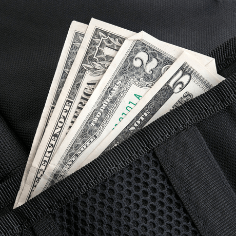 Dollar bills in black wallet with pocket.