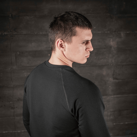 Man wearing M-Tac Raglan Athlete black sweatshirt with raglan sleeves, back view, ideal for sport and everyday use.