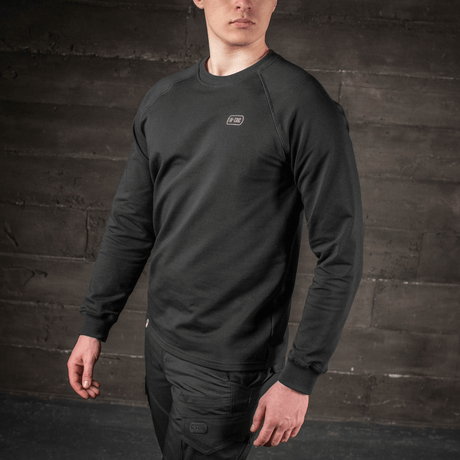 Man wearing M-Tac Raglan Athlete sweatshirt with raglan sleeves in black, ideal for sports and everyday use.