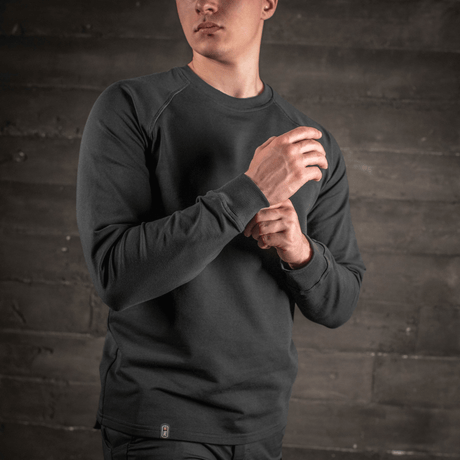 Man wearing M-Tac Raglan Athlete sweatshirt with crew neck and raglan sleeves in black, ideal for sport and everyday.